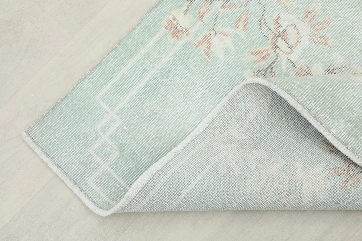 Corner view of the rug's back, showing the consistent knotting and structure.