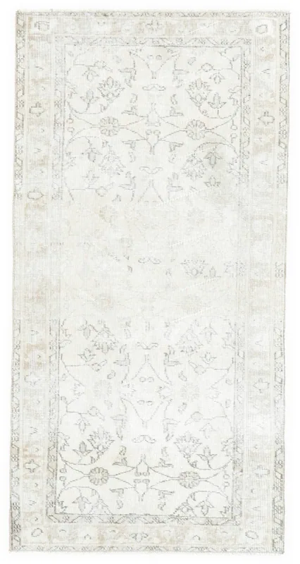 Full overhead view of the ivory and tan hand-knotted vintage Anatolian area rug