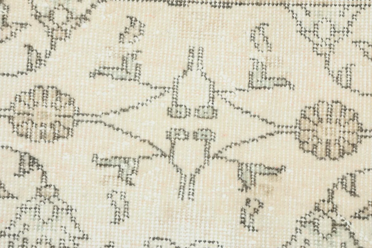 Close-up of the central motifs, revealing the intricate hand-knotting and low pile