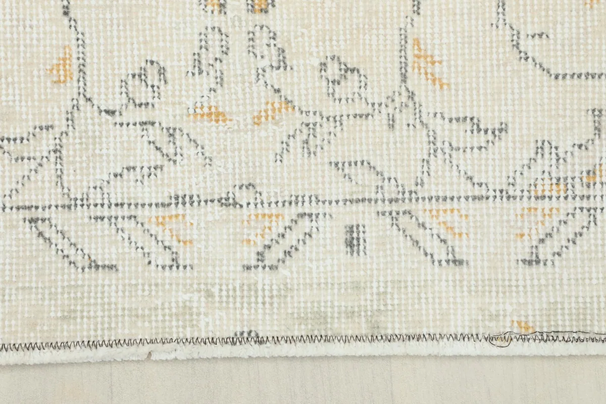 Close-up of the rug's border with geometric designs and original condition