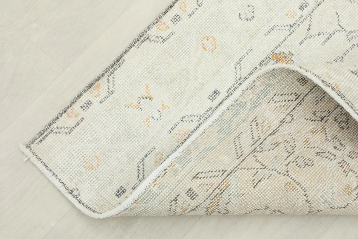 View of the rug folded to show its flexibility and the reverse side