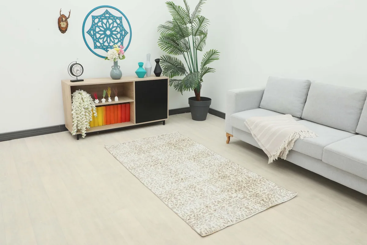 Vintage cream and beige floral rug displayed in a living room setting