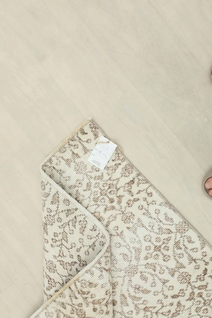 View of the back of the rug, showing the cotton foundation and hand-knotting