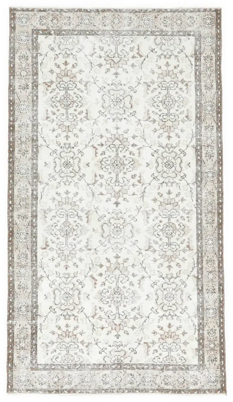 Full overhead view of the 3'8" x 6'7" ivory vintage Anatolian rug with floral and geometric motifs.