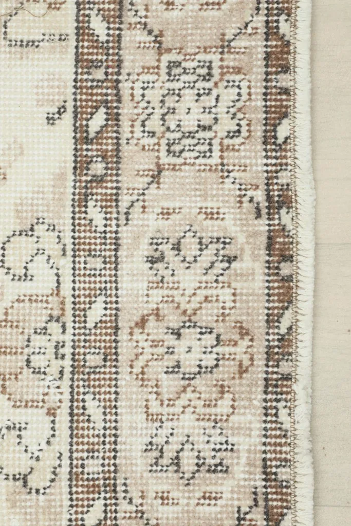 Close-up of the rug's border and edge, illustrating the transition from the main field to the fringe.