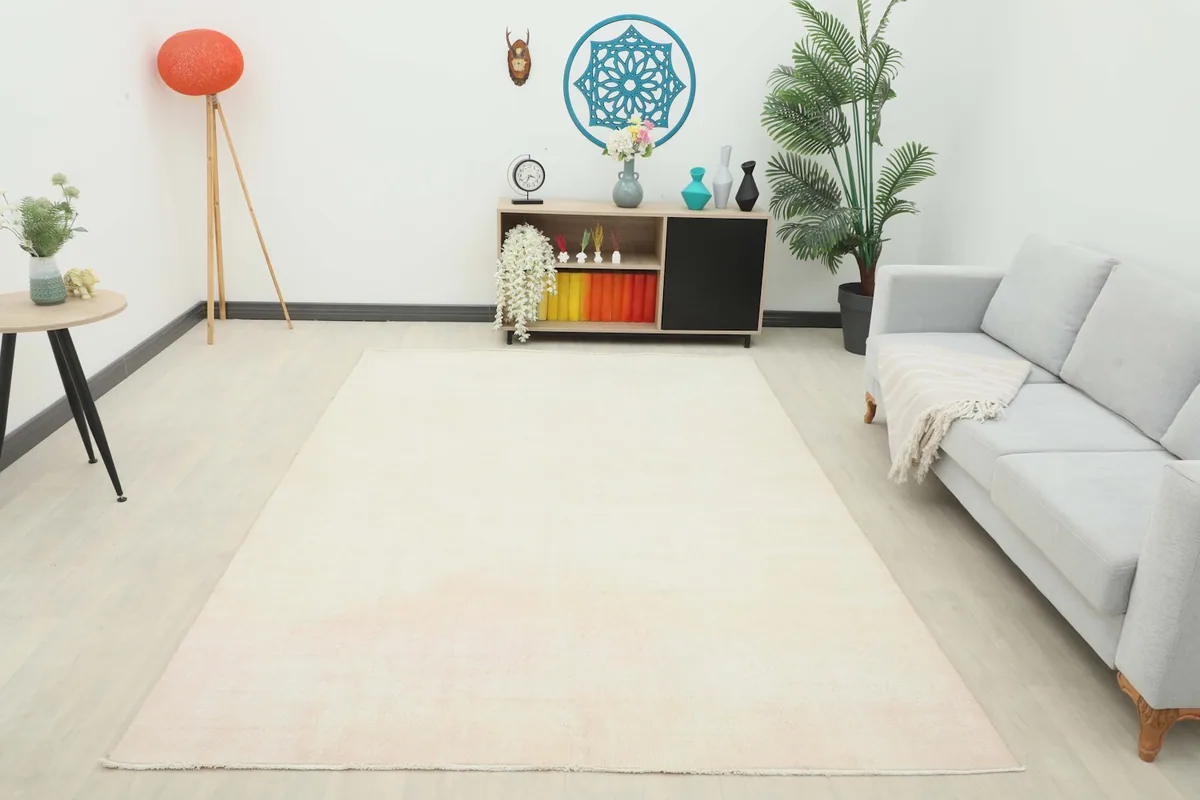 Full room view of the cream and rose area rug, providing a sense of scale and how it brightens the space
