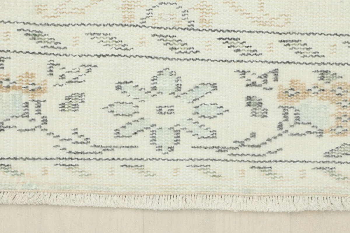 Detail of the rug's end border with geometric patterns and short fringe