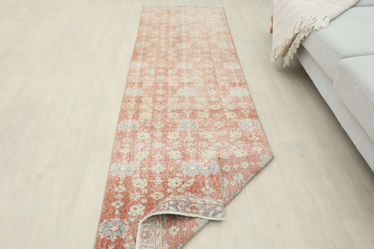 Runner rug partially folded, showing its flexibility and the back of the rug