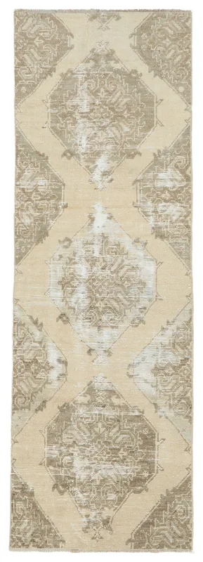 Full overhead view of the beige and brown geometric vintage Anatolian runner rug