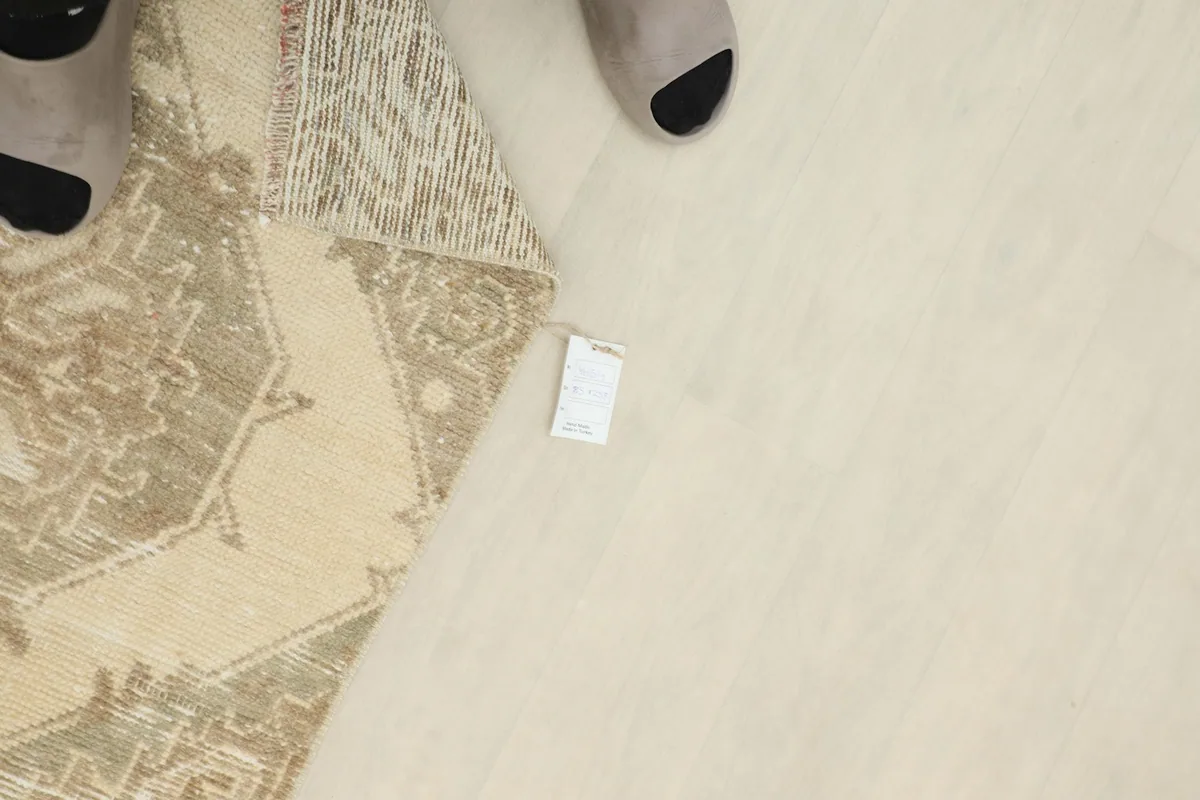 Detail shot with a small tag near the rug, showing scale and texture