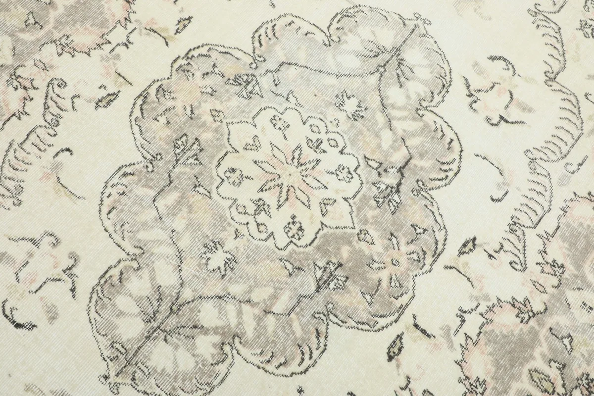 Close-up of the central medallion design, highlighting the ivory and gray colors