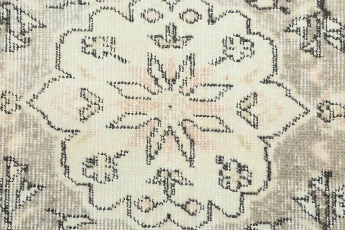 Detailed view of the intricate floral and geometric patterns within the medallion