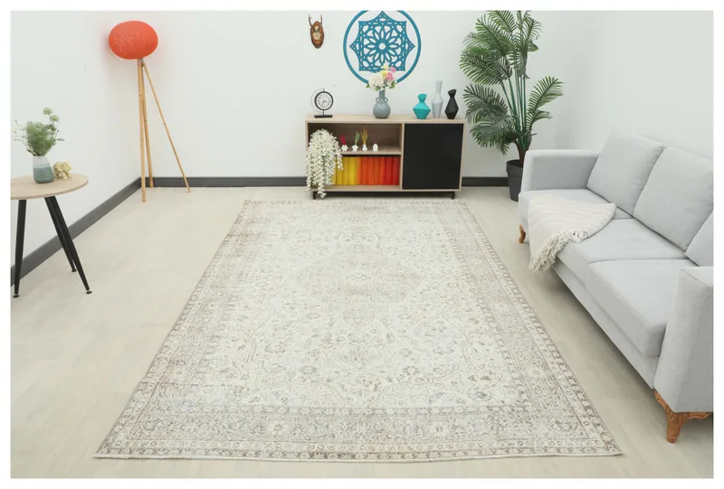 Full top view of the 6'5" x 10'0" ivory floral medallion vintage Anatolian rug on a white background.