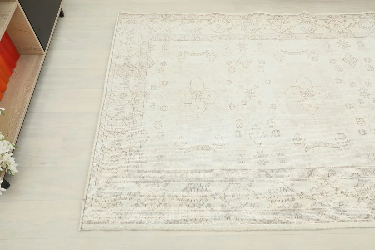 Overhead angled shot of the rug's surface, showing the subtle color variations and motifs.