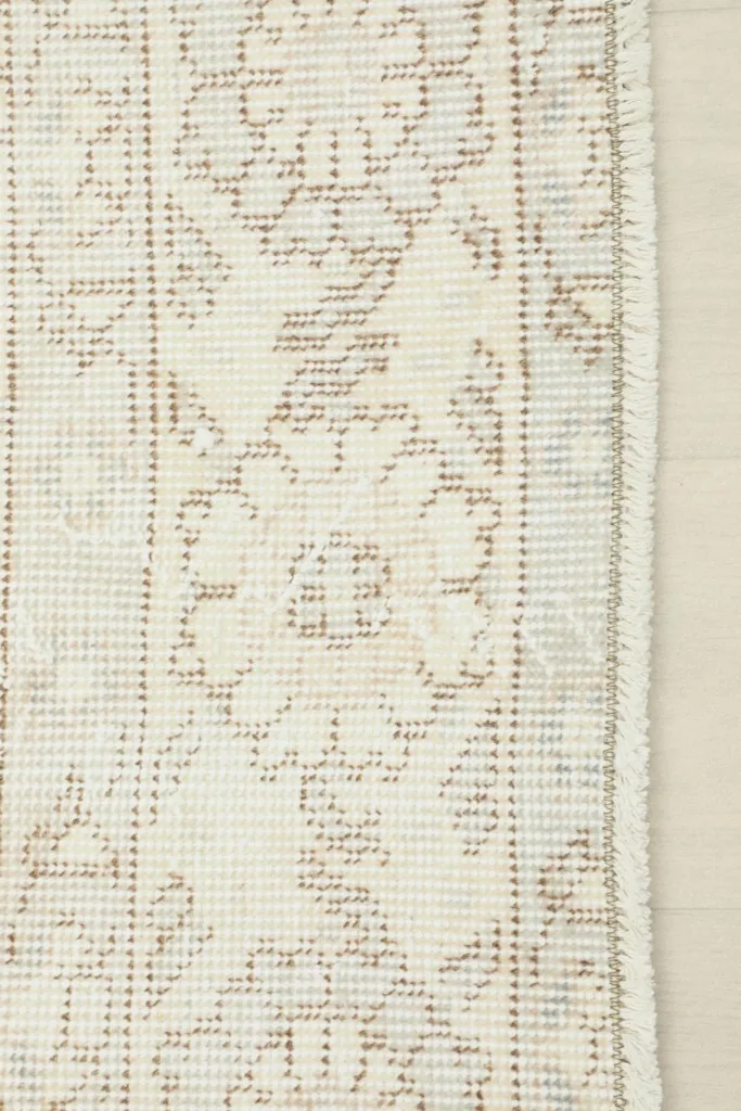 View of the back of the hand-knotted rug, revealing the intricate weaving and cotton foundation.