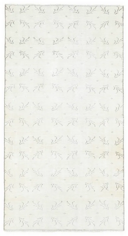Full overhead view of the 3'5" x 6'4" cream geometric sprig vintage Anatolian wool rug on a white background.