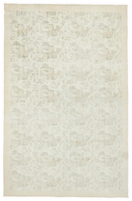 Full overhead view of the 6'9" x 10'6" ivory and tan floral vintage Anatolian area rug on a white background.