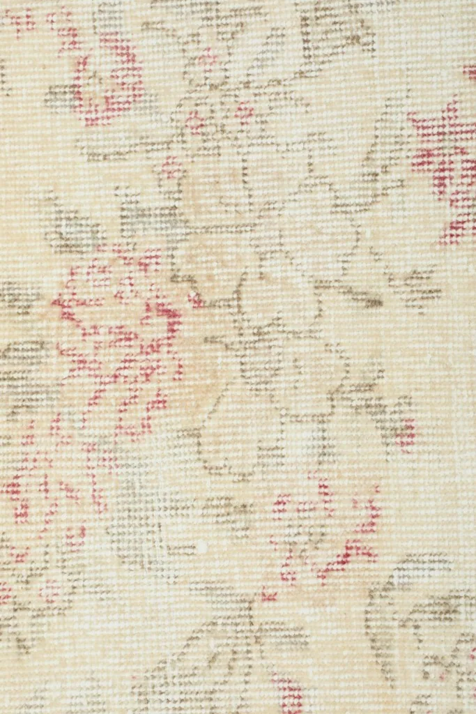 Detailed view of the low wool pile and intricate knotting of the vintage rug