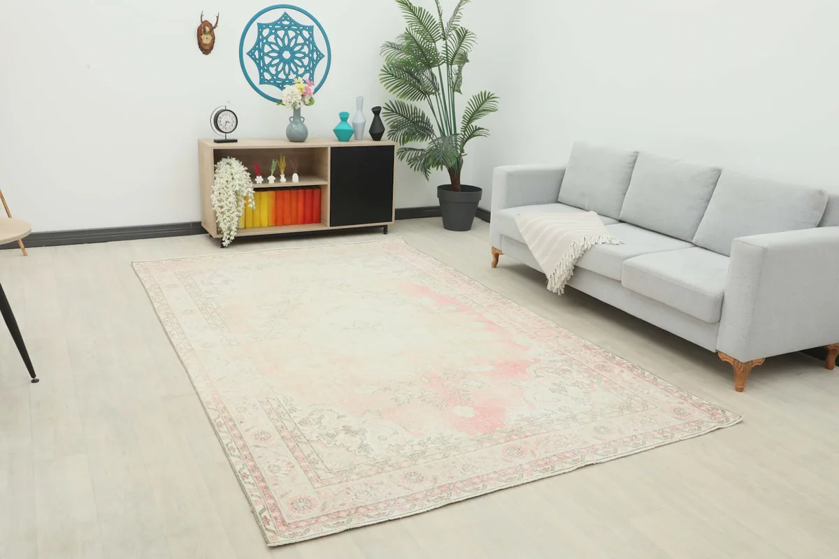 Vintage Anatolian rug displayed in a bright living room setting with a light-colored sofa and minimalist decor.