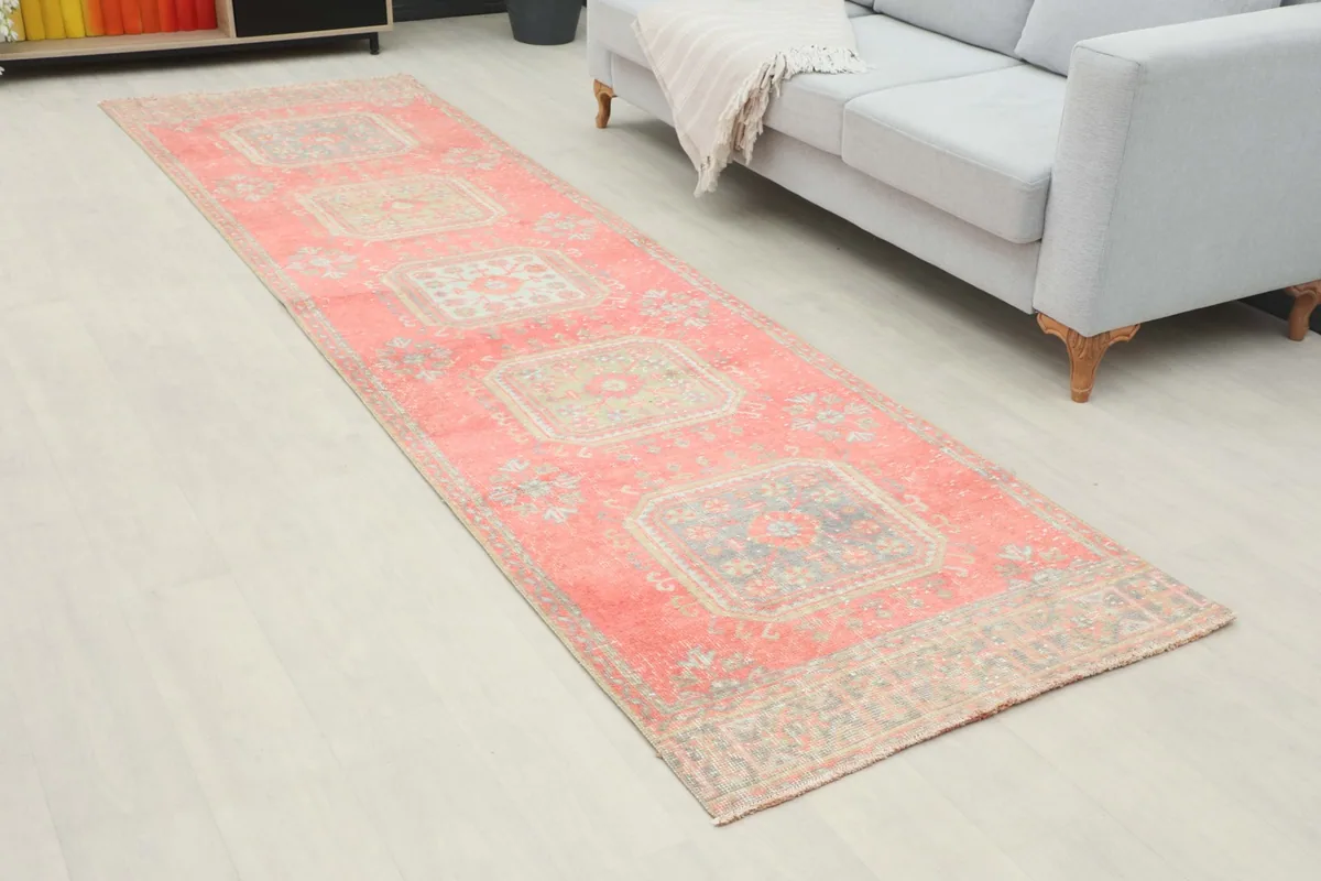 Angle view of the rose runner rug in a modern living space, showing its length and pattern.