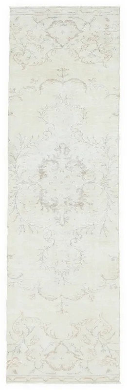 Full overhead view of the ivory beige vintage runner rug on a white background.