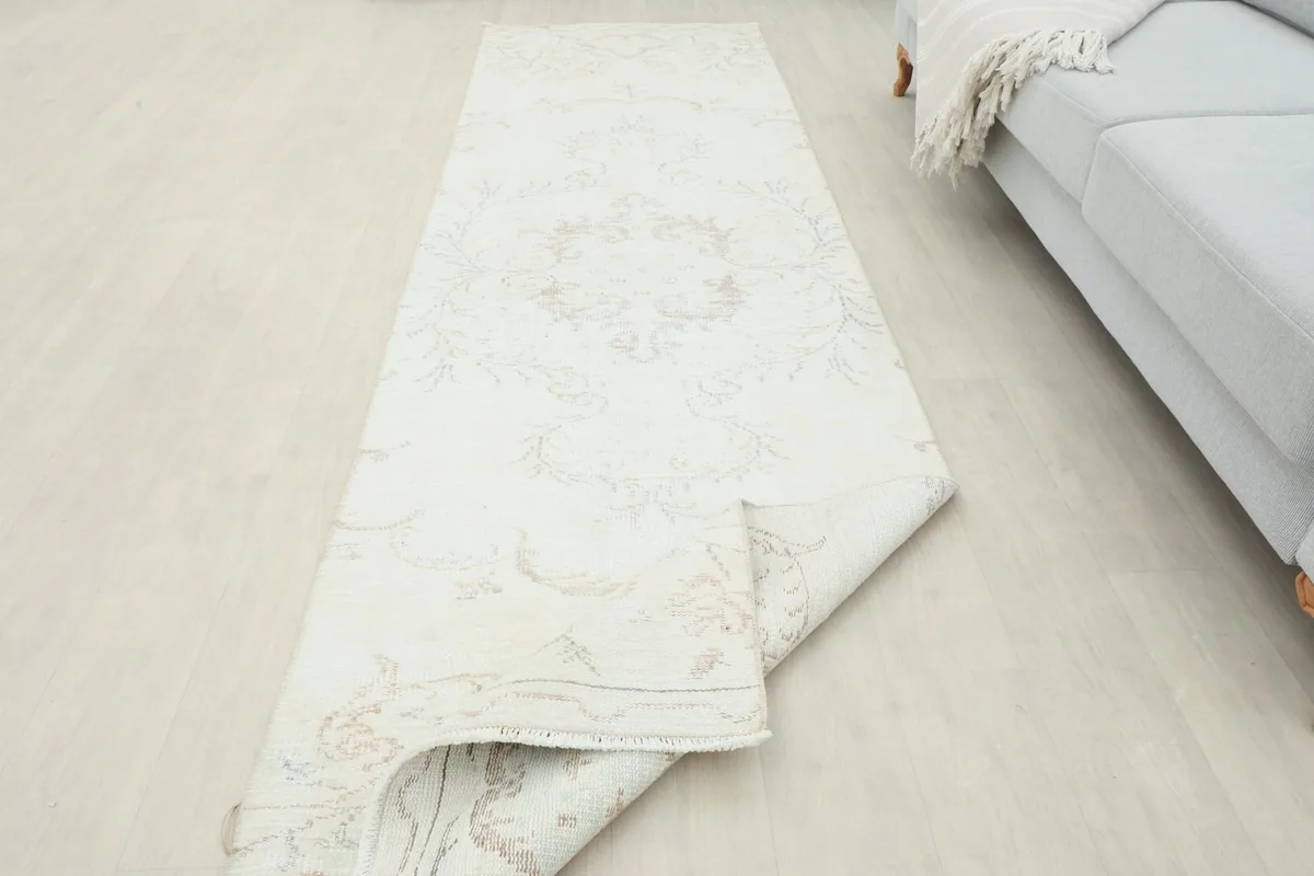 View of the runner rug partially folded, illustrating its flexibility and construction.