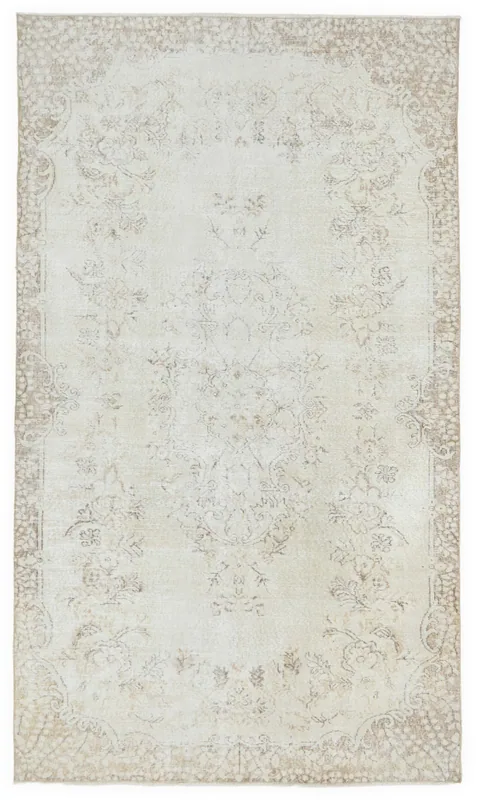Full top view of a cream and tan vintage Anatolian area rug with a floral medallion pattern