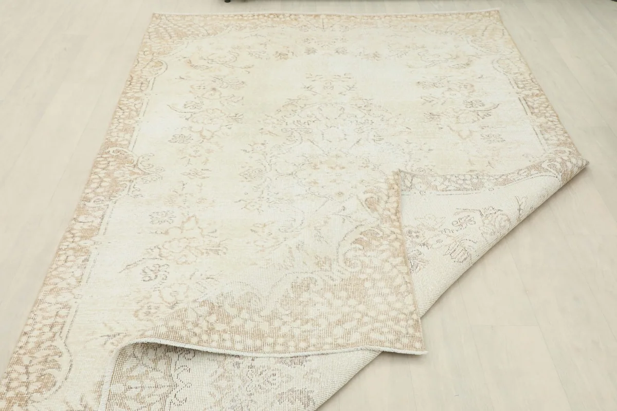 Rug partially folded back, revealing the reverse side and the quality of the knotting