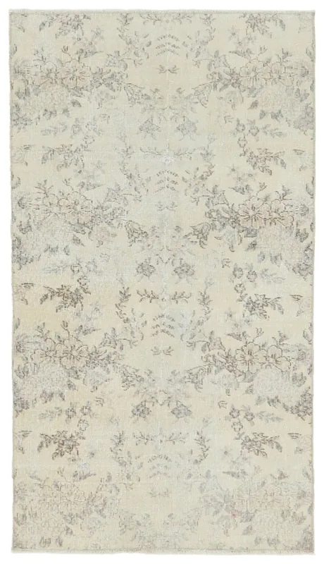 Full overhead view of the ivory and gray floral vintage Anatolian rug