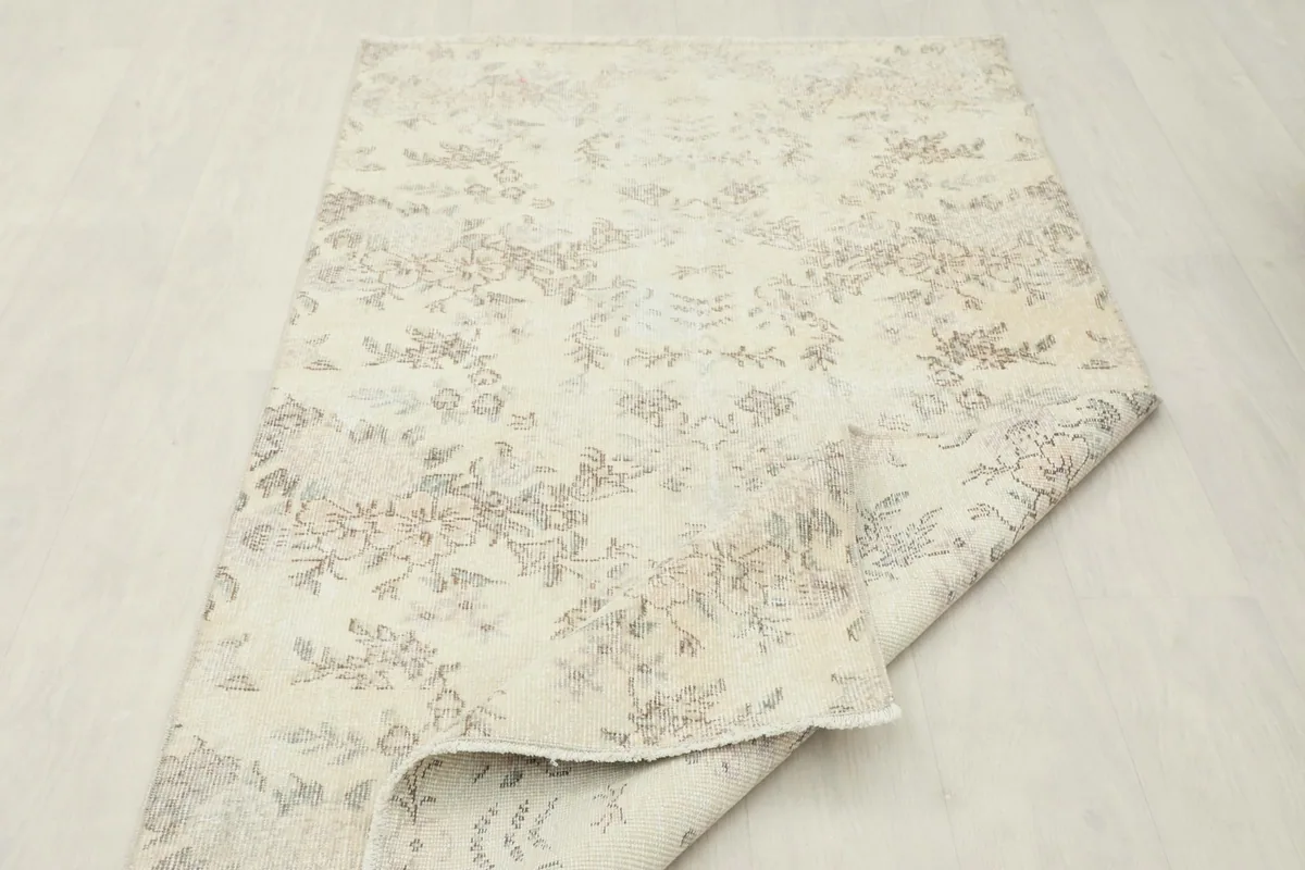 Angled view of the rug with one corner folded, showing the reverse side