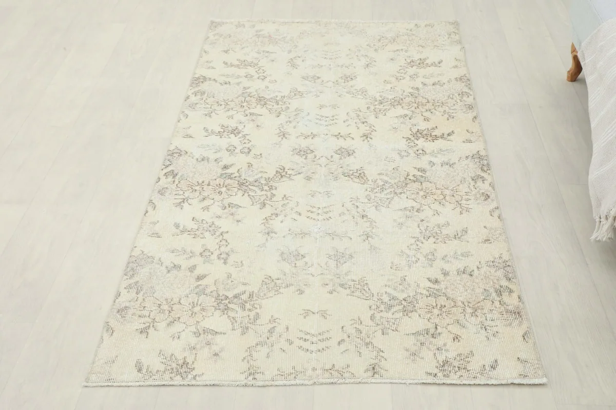 Overhead view of the ivory floral rug from a slight angle, showcasing its full design