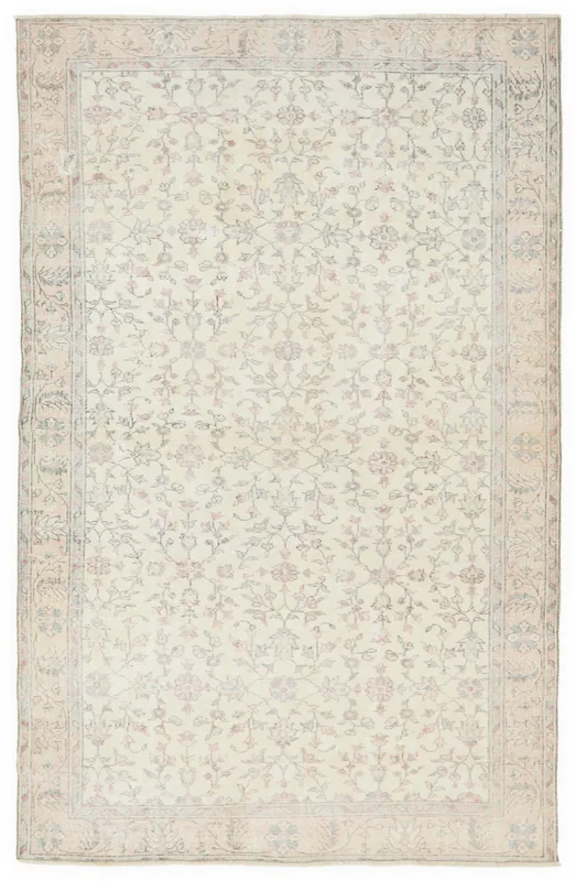 Full overhead view of the 5'7" x 8'7" ivory floral Anatolian rug on a white background