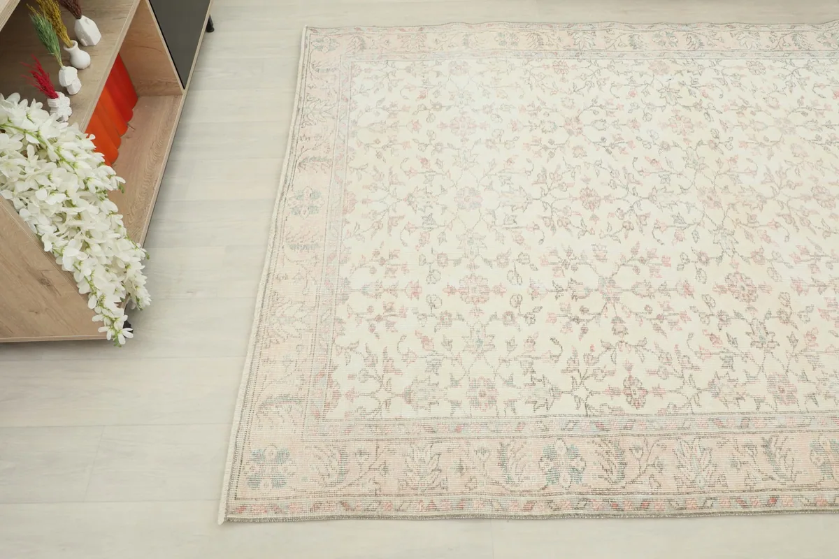 Another angle shot highlighting the ivory field and rose floral motifs of the area rug