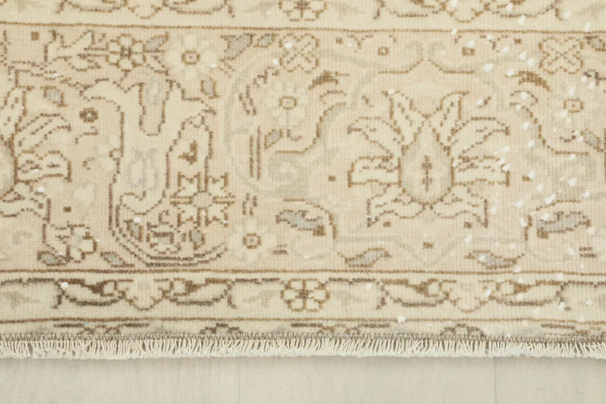Detail of the rug's border showing the hand-knotted wool pile and short fringe