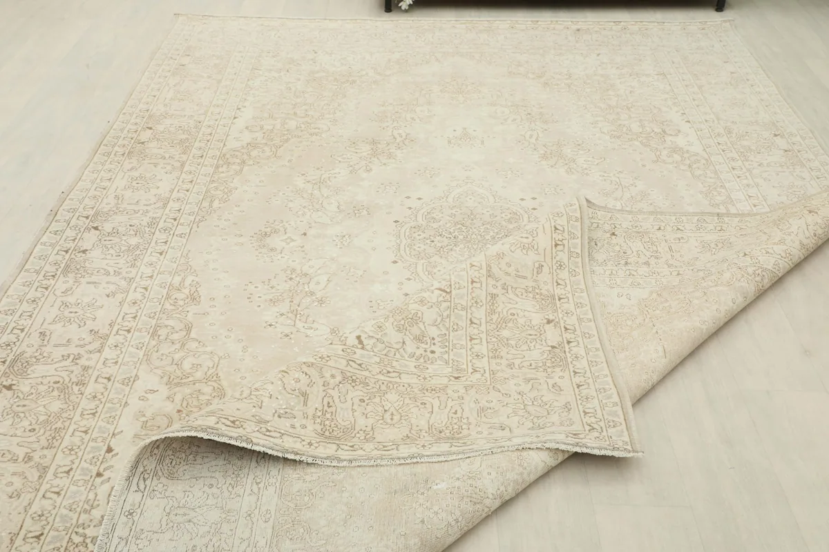 Rug partially folded, showing the flexibility and thickness of the vintage wool pile