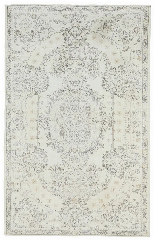 Full overhead view of the 6x9 cream vintage Anatolian area rug with gray and tan medallion