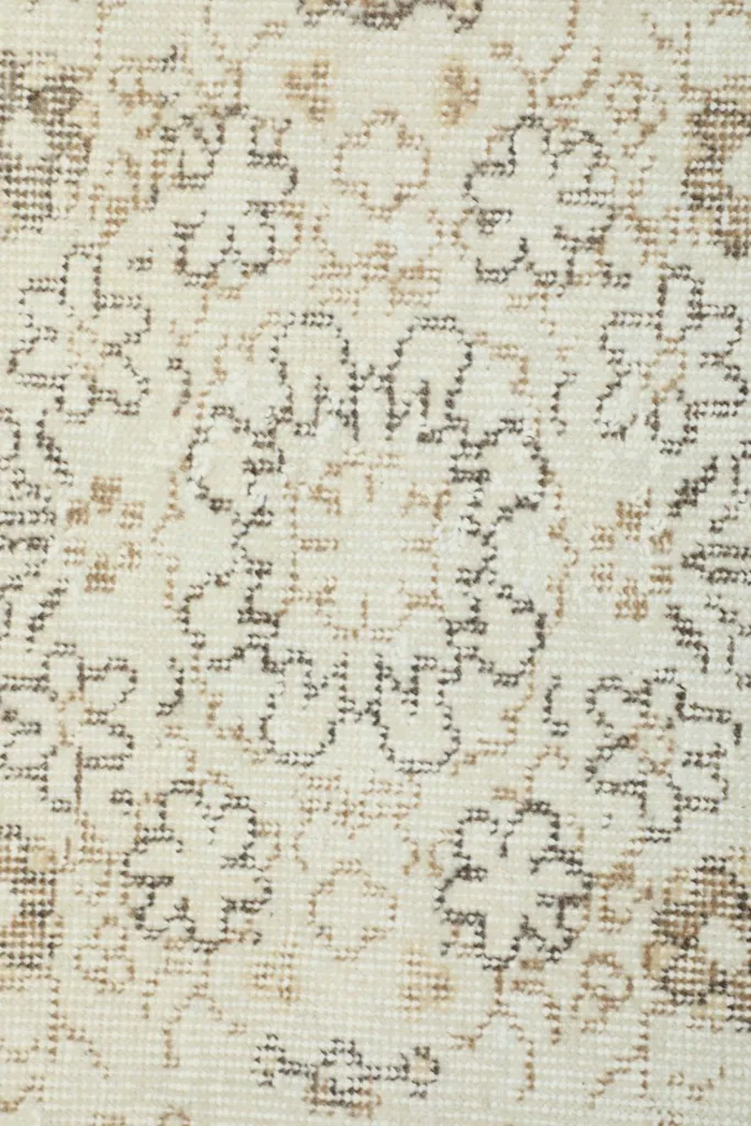 Detailed view of the hand-knotted wool pile and the intricate floral patterns