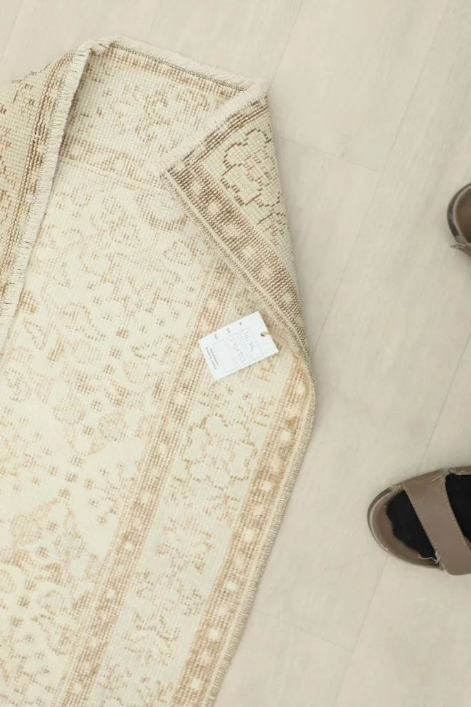 View of the rug's underside, displaying the cotton foundation and the neat hand-knotted construction.
