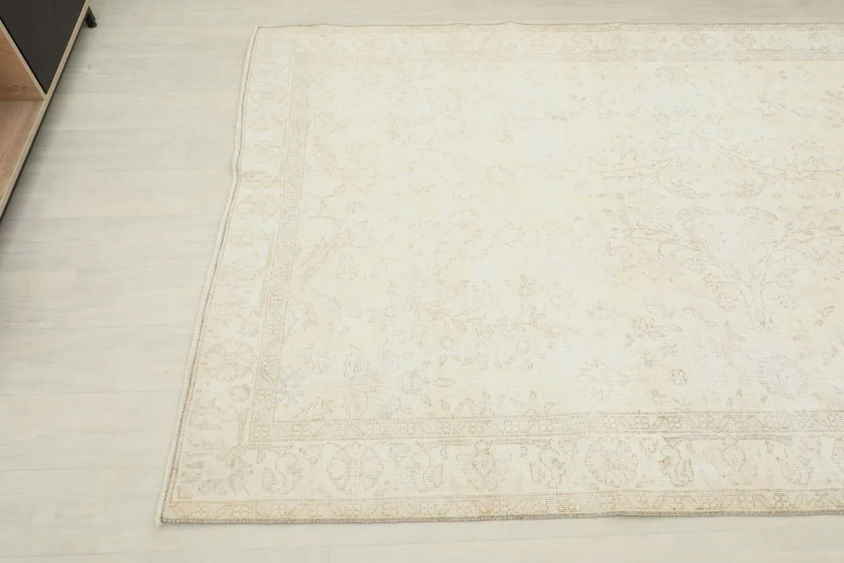 Another corner view of the vintage wool rug, showing its rectangular shape and border