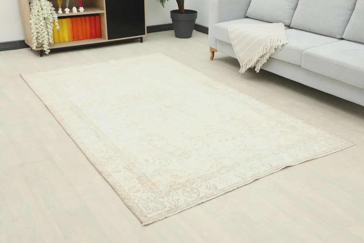Angle view of the ivory and beige floral rug laid out in a modern living space