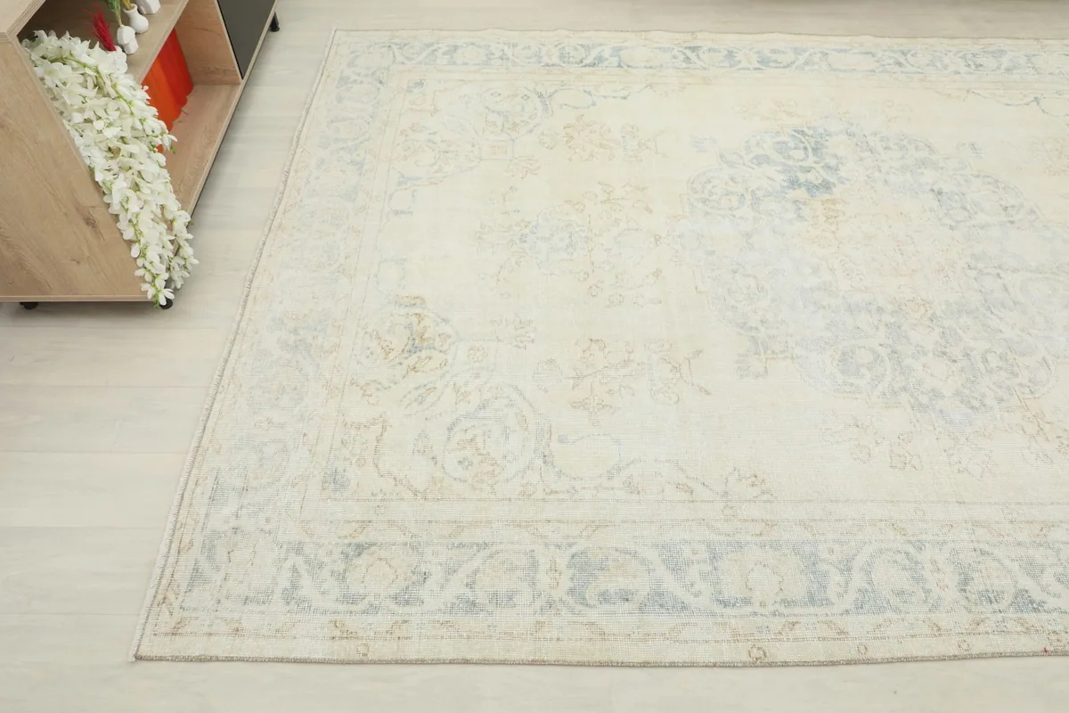 Angled view showing the subtle patterns and colors of the vintage rug from above.