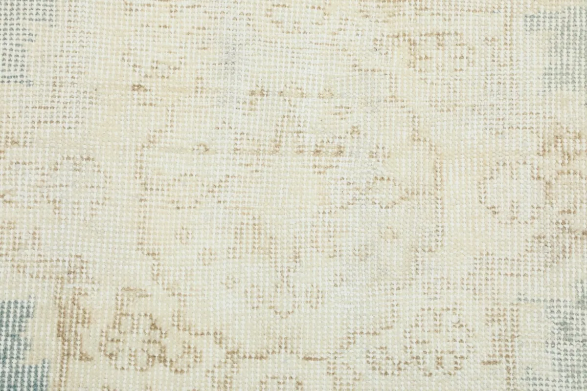 Close-up showing the low wool pile and texture of the hand-knotted vintage rug.