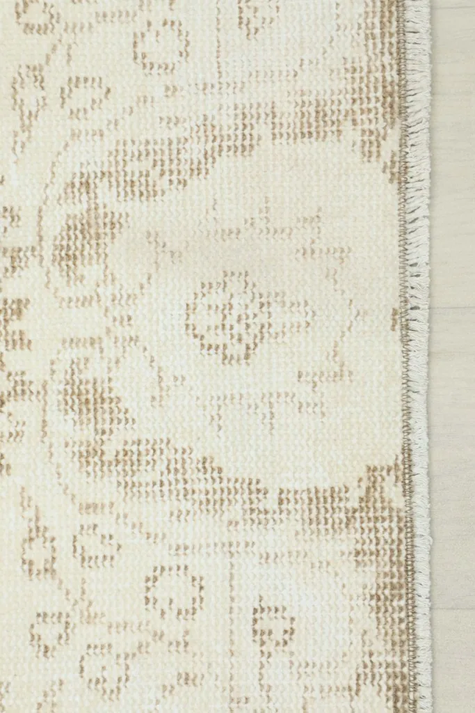 Close-up of the rug's edge, showing the short fringe and the tightly woven structure.