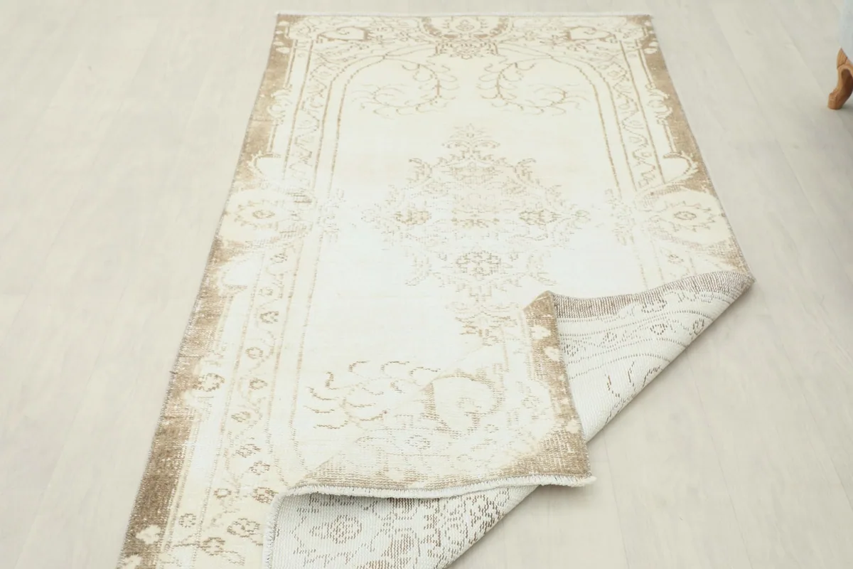 Rug partially folded to showcase its flexibility and the consistent pattern from different angles.