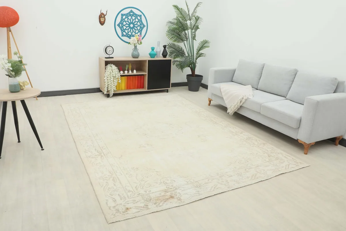 Ivory vintage area rug in a modern living room setting with a gray sofa