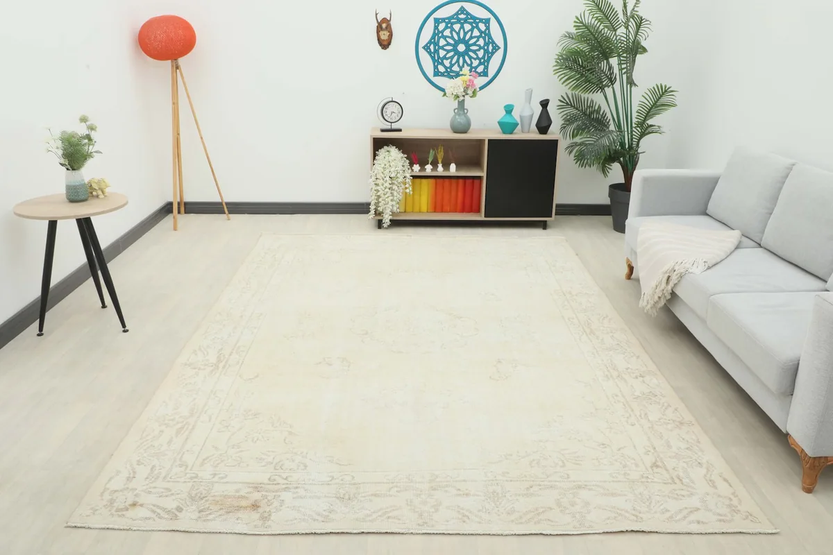 Full room view of the large ivory vintage rug, providing scale and overall appearance