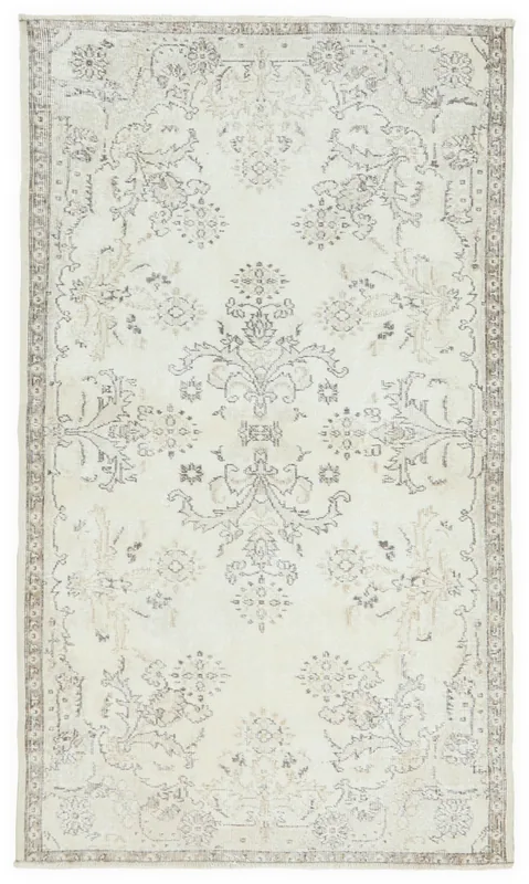 Full top view of the ivory and beige floral medallion vintage Anatolian rug