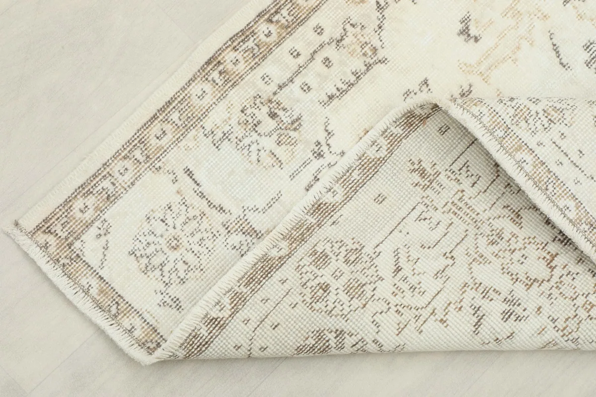 Close-up of the folded rug, revealing the back and foundation texture
