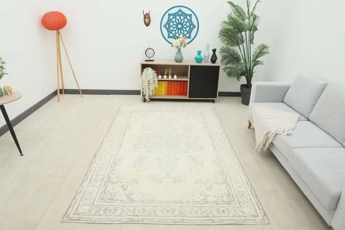 Full room view of the ivory and gray vintage rug, complementing modern decor elements