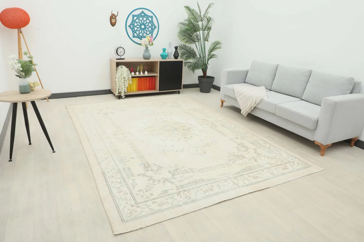 Vintage Anatolian rug in a living room setting with a light gray sofa